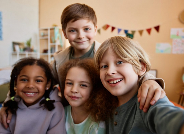 POV of group of happy children taking selfie photo together and looking at camera at home